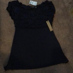 Blue shirt sleeve shirt. Puckered too area. New